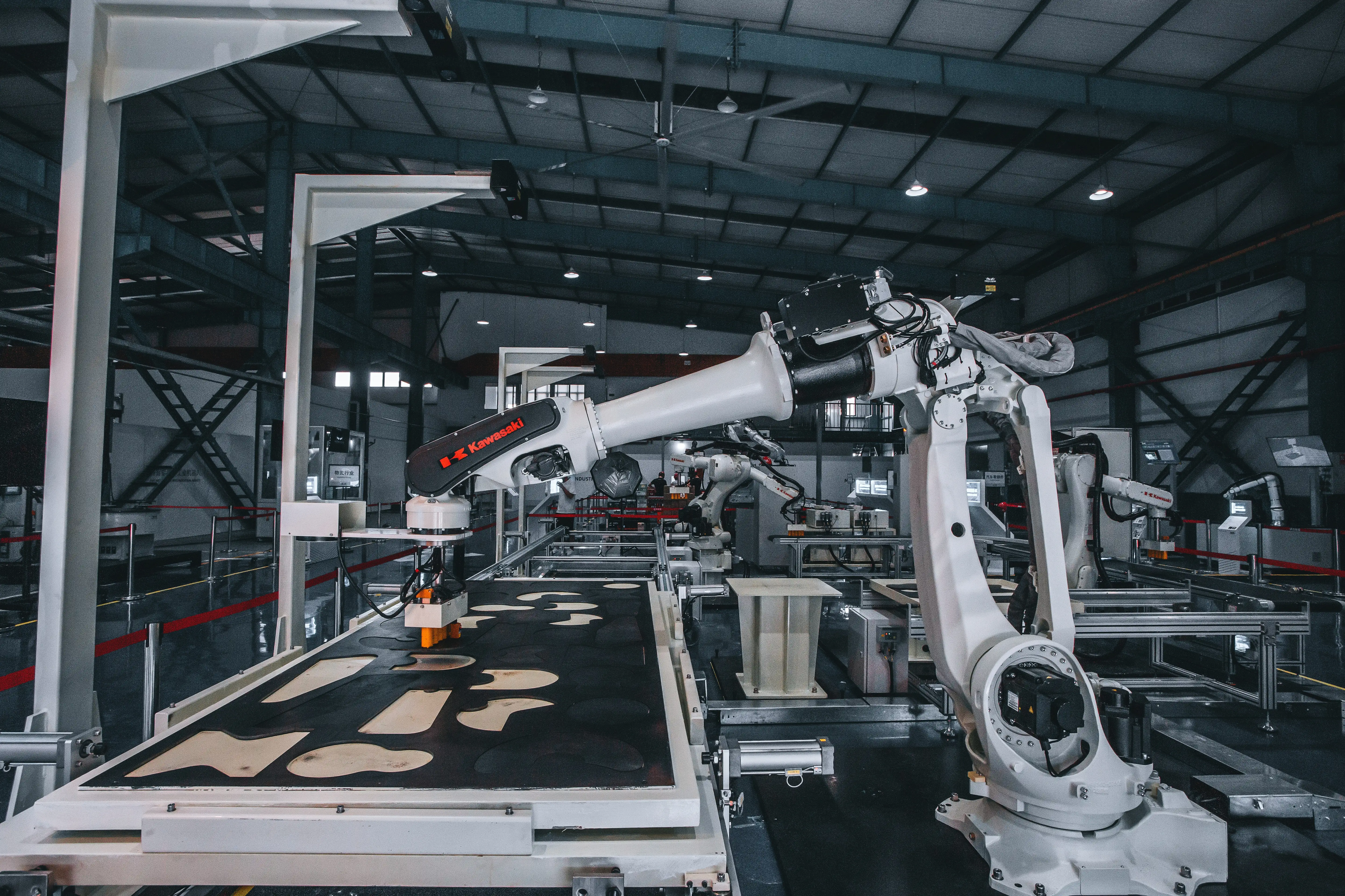 Assembly factory with several Kawasaki industrial robots