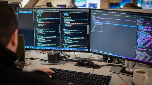 Software developer behind a screen coding